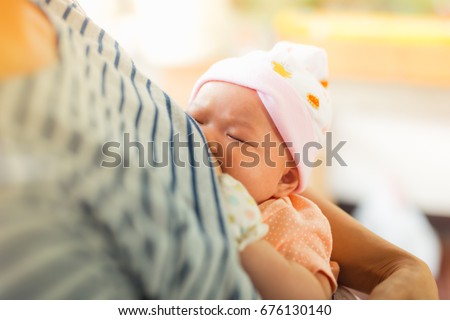 baby is happy at breastfeeding time. it is good for baby to get essential nutrition from milk.