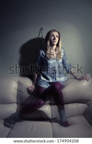 one sad woman sitting on the couch