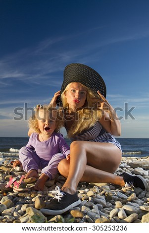 mother and daughter having fun at the sea. Family holiday in nature