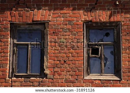 The old brick house with the broken windows
