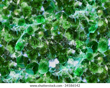 Raw large green emerald. A background from crystals
