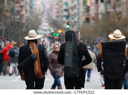 BARCELONA, SPAIN - MARCH 1: Unidentified musicians walking in the middle of Sants Street before carnival parade begin on March 1, 2014 in Barcelona, Spain.