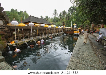 BALI, INDONESIA - SEPTEMBER 30: unidentified people taking a bath in fountains of sacred waters on September 30, 2009 in Tirta Empul, Bali, Indonesia