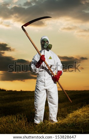 Grim Reaper in bio-hazard protective suit with scythe standing in a field.
