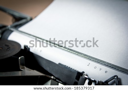 A closeup of an old fashioned typewriter with the words \