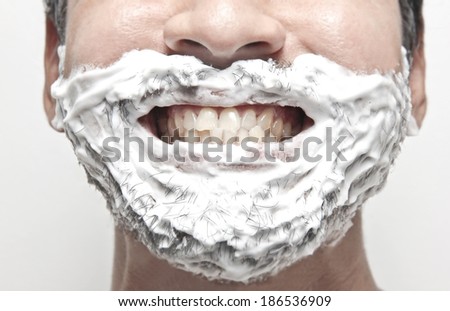 man shaving his face getting ready for the day, smile