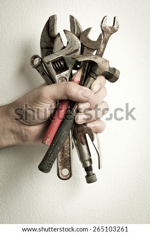 Hand of male holding old tools renovation on white background.