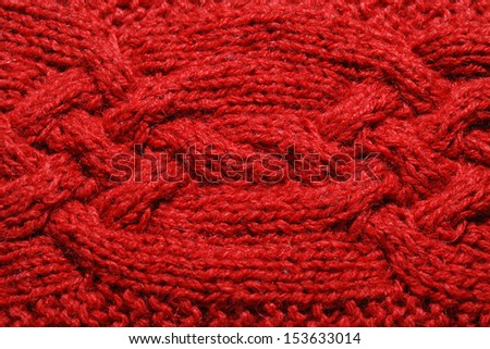 Red knitted cloth is made by hand. It is decorated with bulging braid.