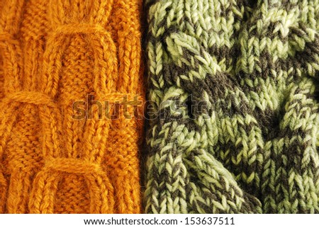 Orange and motley fabrics are side by side. Both knitted clothes are made by hand. They are decorated with raised pattern and photographed closely.