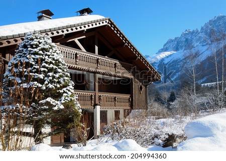 A detached house is surrounded by deep snow in the French Alps.