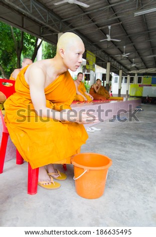 Khonkaen,THAILAND  - April 20: An unidentified Buddhist monk pray near a Buddhist complex in the temple in Khonkaen, Thailand on April 20, 2013