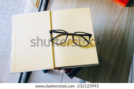 Glasses on the yellow book