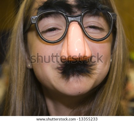 A pretty girl disguised with fake glasses, nose, and mustache