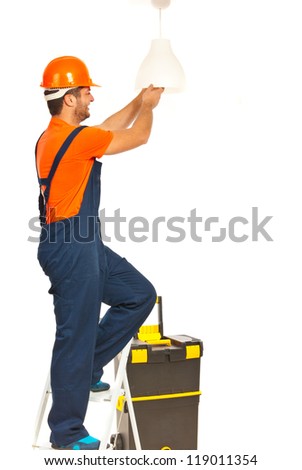 Electrician worker man working and changing a bulb isolated on white background