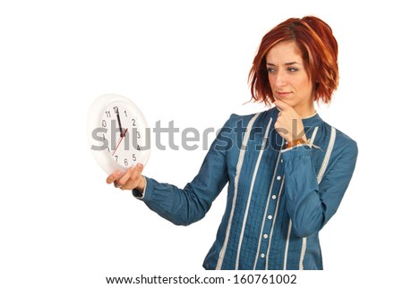Executive woman with asking face looking to clock isolated on white background