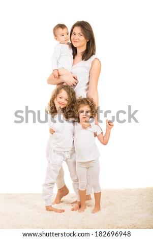 Happy family of four members standing on fur carpet home