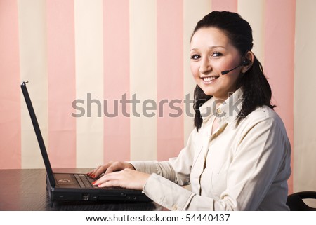 Beauty young woman support operator with laptop smiling,copy space for text message in left part of image on vertical blinds background