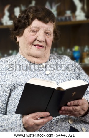 stock-photo-elderly-woman-s-reading-bible-in-her-living-room-and-having-a-positive-face-54448921.jpg