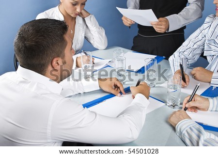 Close up of business people writing at having a meeting