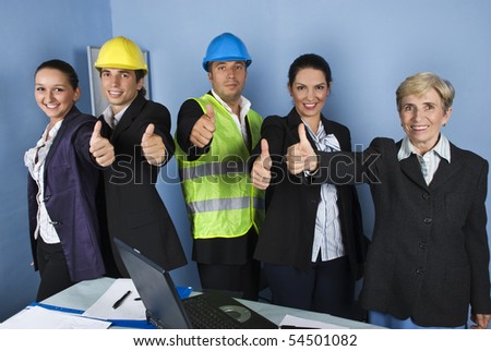 Five engineers team give thumbs up and smiling in a office showing successful in business