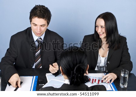 Business people having a job interview with a woman who stays with back and they having fun and laughing
