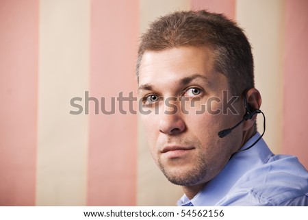Portrait of mid adult man operator worker with headset looking at you,vertical,copy space for text message in left part of image