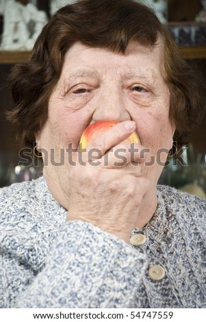 Portrait of  grandma eating an apple