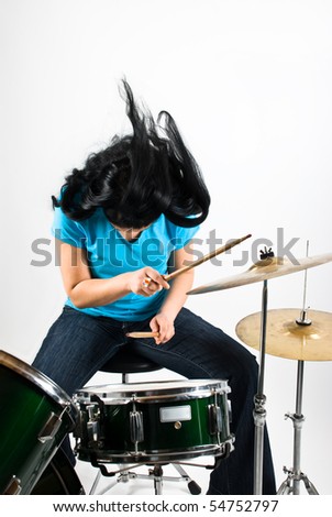 Drummer woman flipping hair feeling the music and play drum kit