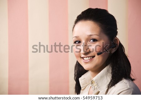Portrait of beauty call center young woman with headset smiling,copy space for text message in left part of image on vertical blinds background