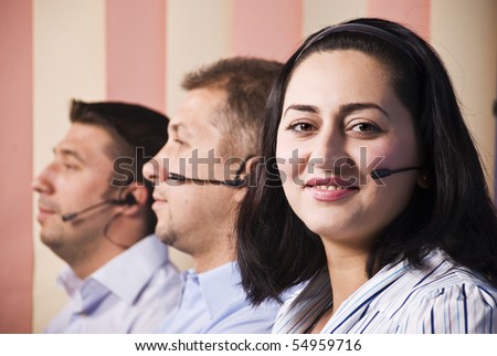 Customer support team close up ,focus on woman that smiling for you