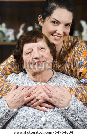 Warm hug with lots of love of a granddaughter who is visiting  her grandmother