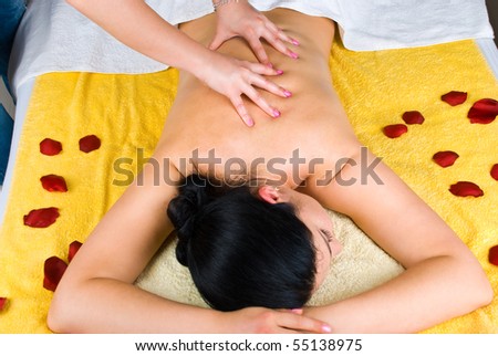 Young woman receiving a professional back massage at spa salon