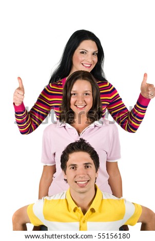 Three happy people  friends standing in a line one above the other or overhead each other and brunette girl giving thumbs up cocept of successful friendship