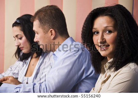 Business office life,focus on first woman that smile for you,the  other two businesspeople having an conversation