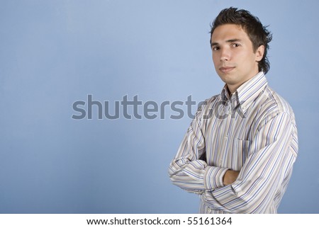 Young modern business man wearing a shirt and standing with arms crossed in front of image,copy space for text message ,isolated on blue background