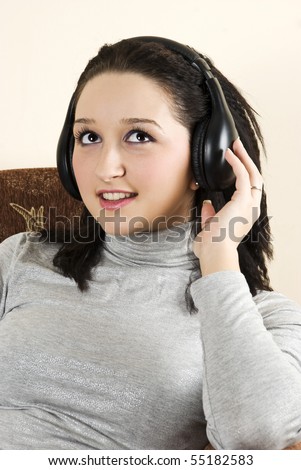 Beauty girl listening music in her couch in living room