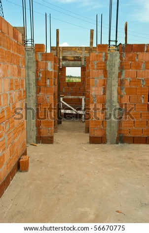 Interior of a house under construction with red bricks