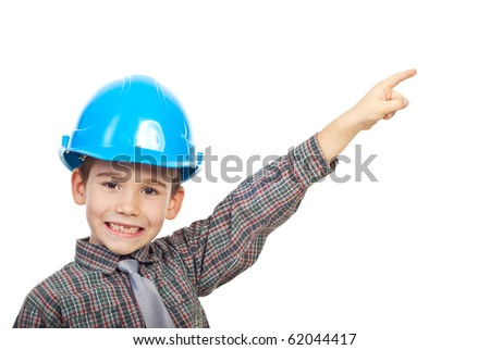 Small architect boy with helmet pointing up to copy space and smiling with his missing teeth isolated on white background