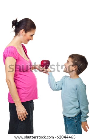 Son giving a big red apple to his pregnant mother and smiling together face to face isolated on white background