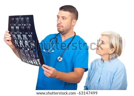 Serious doctor man showing results of magnetic resonance imaginig to a senior patient and both being worried isolated on white background