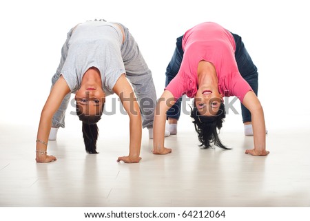 stock photo Two flexible women doing back bend on floor over white 