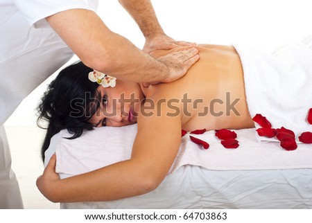 Beauty woman getting back spa massage by a professional masseur man