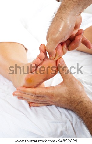 Masseur make reflexology massage to woman' foot  pressure toe