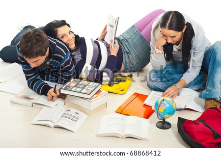 Three friends studying together home and sitting on wooden floor