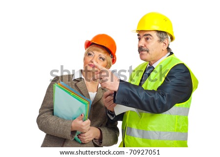 Mature architect man pointing   away and showing to his colleague woman isolated on white background