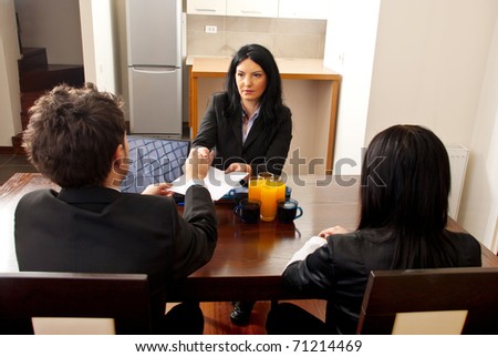 Manager woman giving  to a business man a contract for signing at job interview