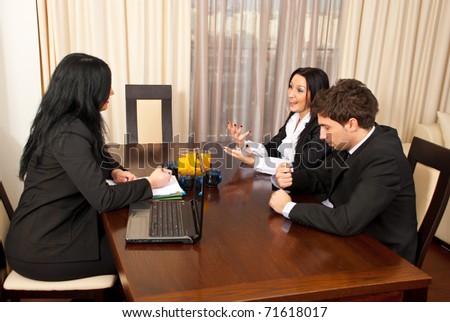 Three business people having conversation at job interview