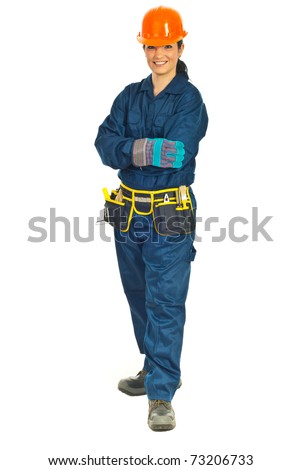 Full length of smiling constructor worker woman standing with hands crossed isolated on white background