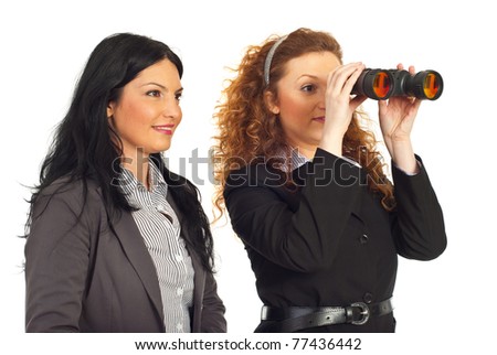 Two happy business women looking into binocular to the future isolated on white background