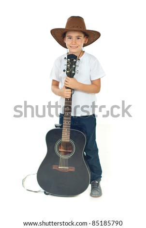 Full length of happy boy wearing cowboy hat and classic guitar against white background